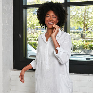 Model smiling towards camera wearing White Oversized Linen Shirt Dress.